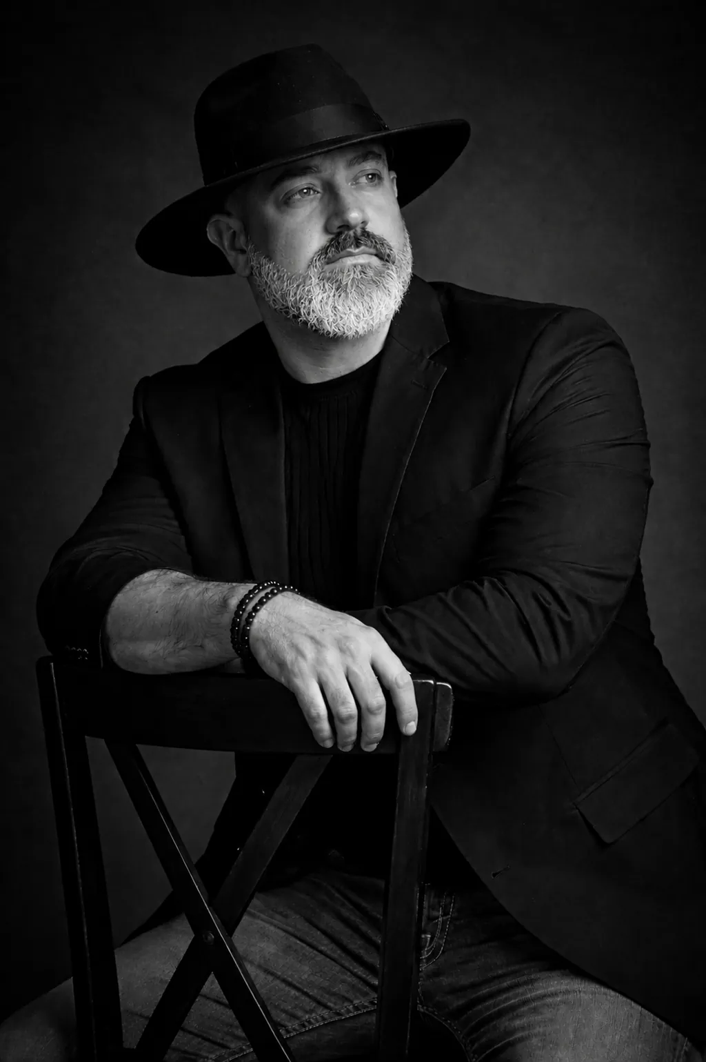 David Adam Kurz Forged Into Man podcast host portrait in black hat and jacket